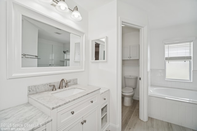 183 Frante Ave NE, Palm Bay, FL 32907 - bathroom with vanity, a garden tub, and a tile shower