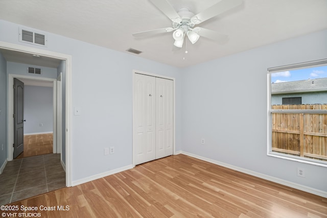 183 Frante Ave NE, Palm Bay, FL 32907 - unfurnished bedroom with wood finished floors, a closet, and ceiling fan
