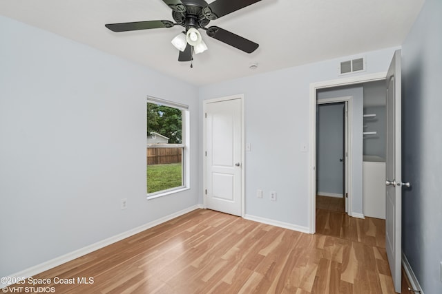 183 Frante Ave NE, Palm Bay, FL 32907 - unfurnished bedroom featuring light wood finished floors and a ceiling fan