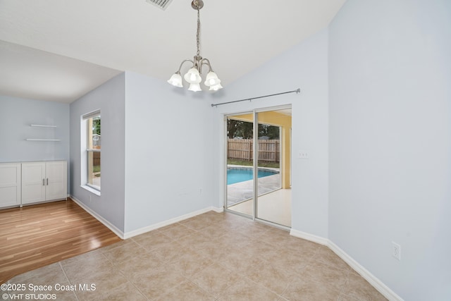 183 Frante Ave NE, Palm Bay, FL 32907 - empty room featuring a chandelier and vaulted ceiling