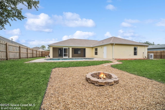 183 Frante Ave NE, Palm Bay, FL 32907 - rear view of house featuring stucco siding, a fenced backyard, an outdoor fire pit, a shingled roof, and a patio area