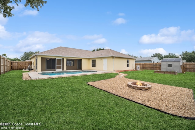 183 Frante Ave NE, Palm Bay, FL 32907 - back of property with a storage shed, a fire pit, a fenced backyard, and stucco siding