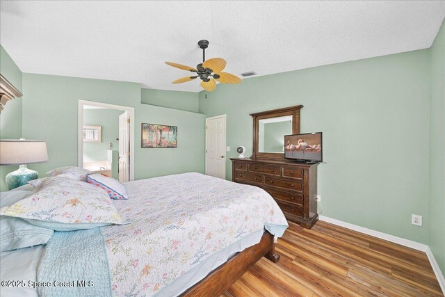 2627 Deercroft Dr, Melbourne, FL 32940 - bedroom with wood finished floors, ceiling fan, connected bathroom, and a textured ceiling