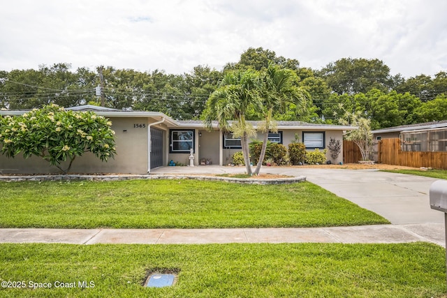 1565 Venus St, Merritt Island, FL 32953 - ranch-style house featuring stucco siding and concrete driveway