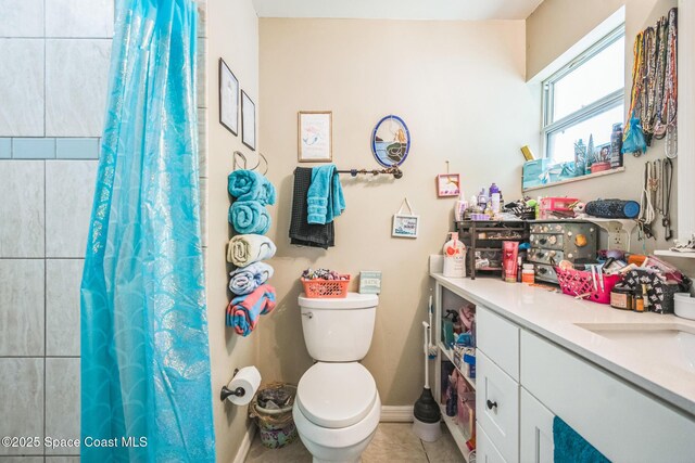 1565 Venus St, Merritt Island, FL 32953 - full bathroom with vanity, curtained shower, and tile patterned flooring
