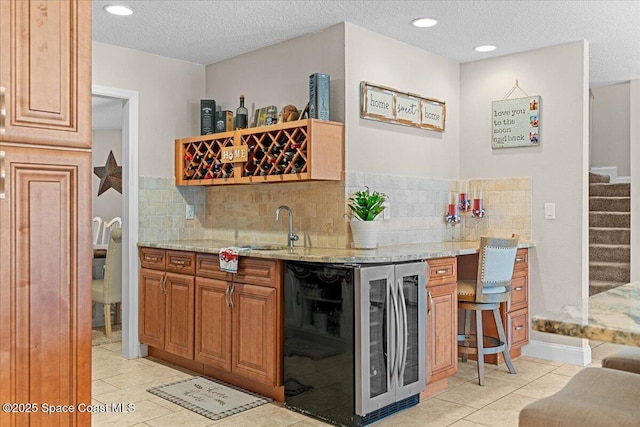 260 Utopia Cir, Merritt Island, FL 32952 - indoor wet bar featuring beverage cooler, light tile patterned floors, stairway, decorative backsplash, and a textured ceiling