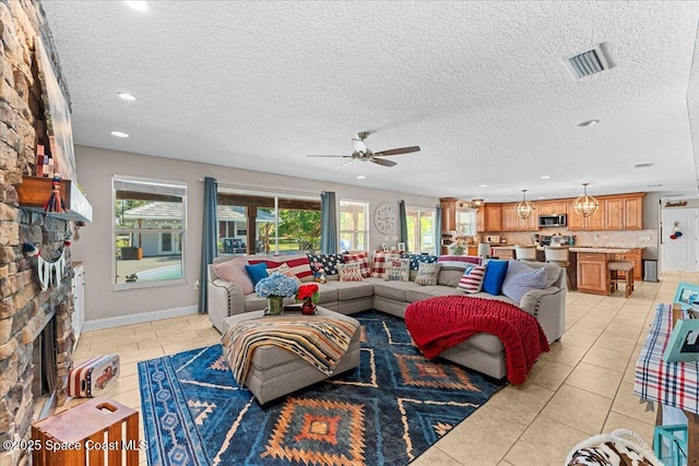 260 Utopia Cir, Merritt Island, FL 32952 - living room with a fireplace, ceiling fan, light tile patterned flooring, a textured ceiling, and recessed lighting