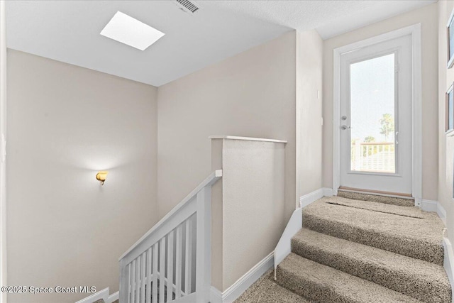 260 Utopia Cir, Merritt Island, FL 32952 - staircase featuring a skylight and baseboards
