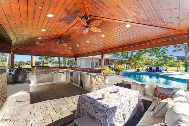 260 Utopia Cir, Merritt Island, FL 32952 - view of patio / terrace with exterior kitchen, an outdoor living space, a ceiling fan, and an outdoor pool