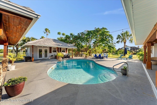 260 Utopia Cir, Merritt Island, FL 32952 - swimming pool with french doors, a patio area, a storage structure, and an outbuilding