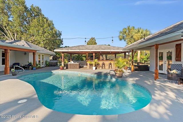 260 Utopia Cir, Merritt Island, FL 32952 - swimming pool featuring french doors, a patio, and an outdoor hangout area