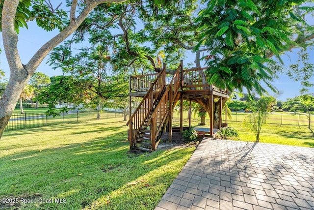 260 Utopia Cir, Merritt Island, FL 32952 - view of play area with a patio area, a fenced backyard, stairway, and a wooden deck