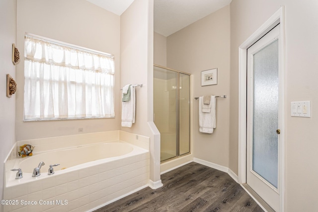 1166 Morgan Cir NE, Palm Bay, FL 32905 - bathroom with a garden tub, wood finished floors, and a shower stall