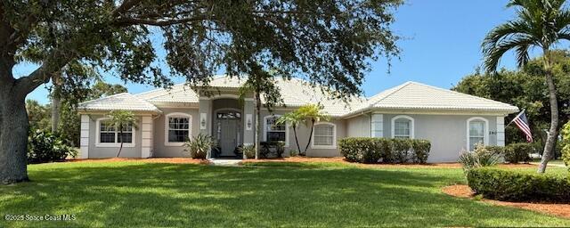 290 Utopia Cir, Merritt Island, FL 32952 - view of front of home with stucco siding and a front yard