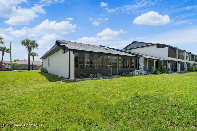743 Palm Springs Cir, Satellite Beach, FL 32937 - back of house featuring a sunroom, stucco siding, and roof with shingles
