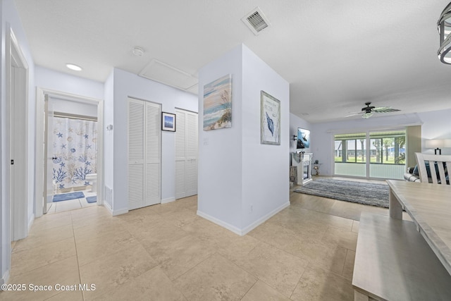 743 Palm Springs Cir, Satellite Beach, FL 32937 - corridor with baseboards and attic access