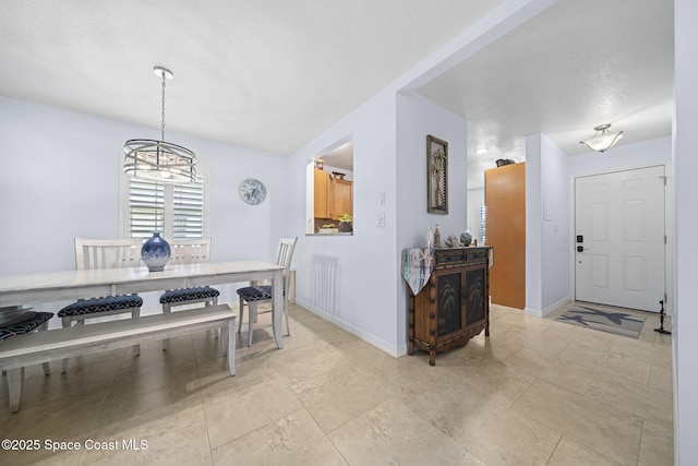 743 Palm Springs Cir, Satellite Beach, FL 32937 - dining room featuring baseboards and a chandelier
