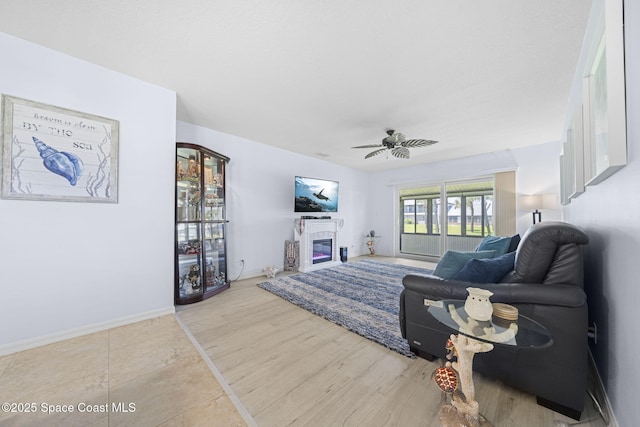 743 Palm Springs Cir, Satellite Beach, FL 32937 - living room with ceiling fan and a glass covered fireplace