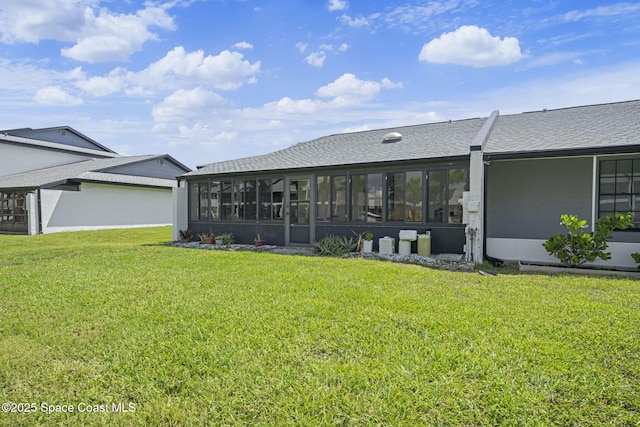743 Palm Springs Cir, Satellite Beach, FL 32937 - back of house featuring a lawn, a sunroom, and roof with shingles