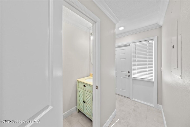 203 6th Ave Unit 9, Melbourne Beach, FL 32951 - hallway featuring crown molding, light tile patterned floors, and a textured ceiling