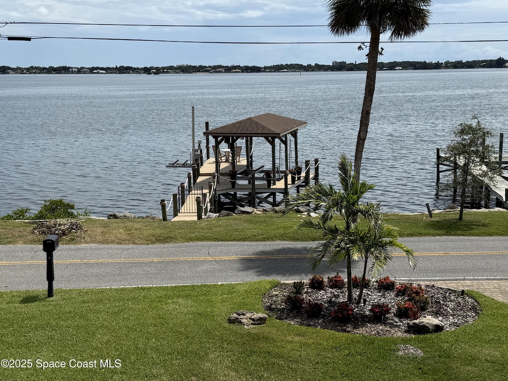 1307 Rockledge Dr, Rockledge, FL 32955 - dock area with boat lift, a water view, and a lawn