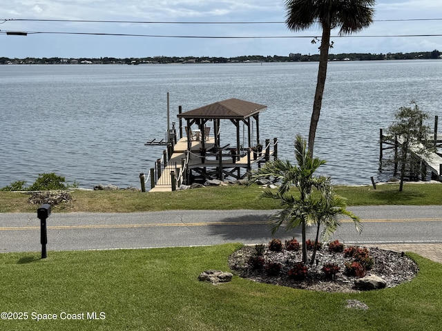 1307 Rockledge Dr, Rockledge, FL 32955 - dock area with boat lift, a water view, and a lawn