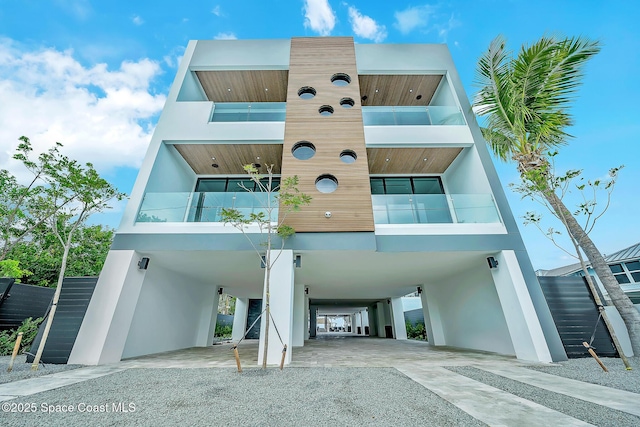 16 Seaside Ave, Key Largo, FL 33037 - view of building exterior featuring a carport, stairway, and gravel driveway
