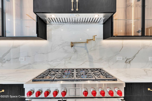 16 Seaside Ave, Key Largo, FL 33037 - kitchen featuring high end stainless steel range, exhaust hood, backsplash, and dark cabinets