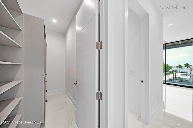 16 Seaside Ave, Key Largo, FL 33037 - corridor with recessed lighting and light marble finish floors