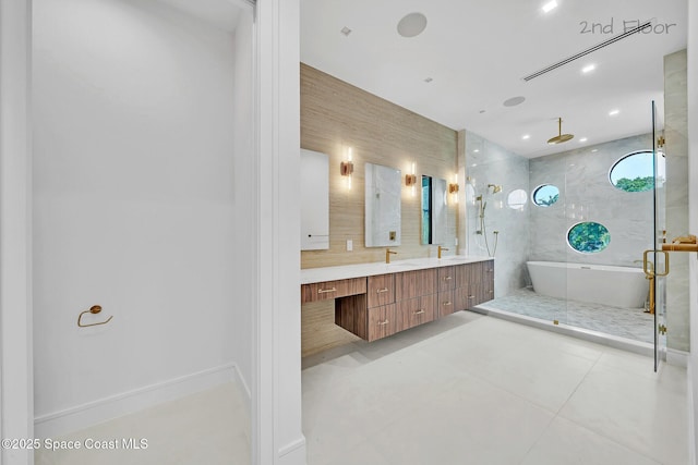 16 Seaside Ave, Key Largo, FL 33037 - bathroom with a stall shower, double vanity, a freestanding bath, tile patterned floors, and recessed lighting