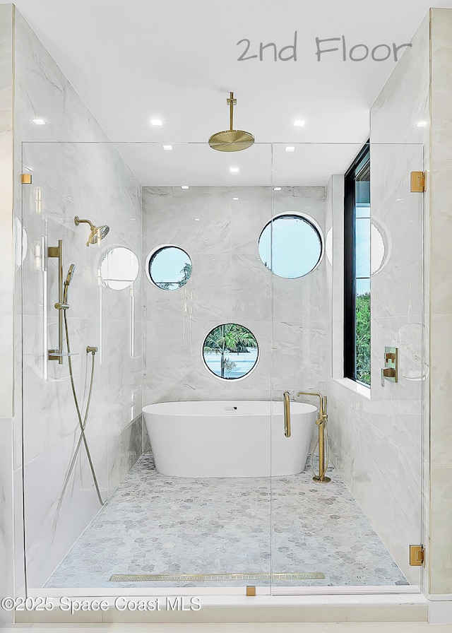 16 Seaside Ave, Key Largo, FL 33037 - full bathroom with tile walls, a marble finish shower, and a freestanding tub