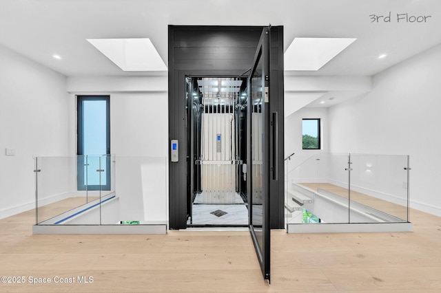 16 Seaside Ave, Key Largo, FL 33037 - hallway featuring a skylight, wood finished floors, and recessed lighting