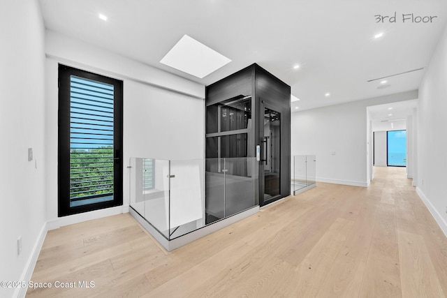 16 Seaside Ave, Key Largo, FL 33037 - hall with light wood finished floors, a skylight, and recessed lighting