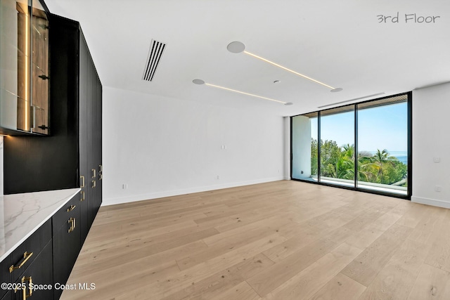 16 Seaside Ave, Key Largo, FL 33037 - unfurnished living room with light wood finished floors and expansive windows