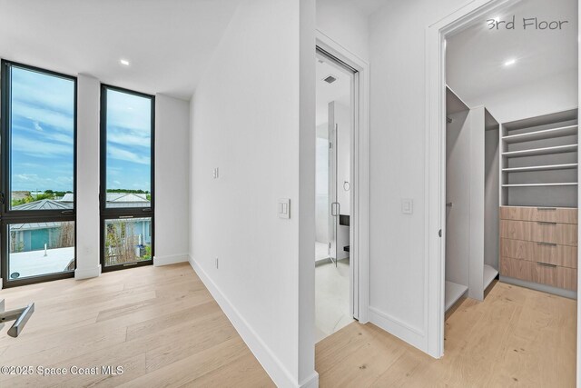 16 Seaside Ave, Key Largo, FL 33037 - corridor with light wood-style flooring and expansive windows