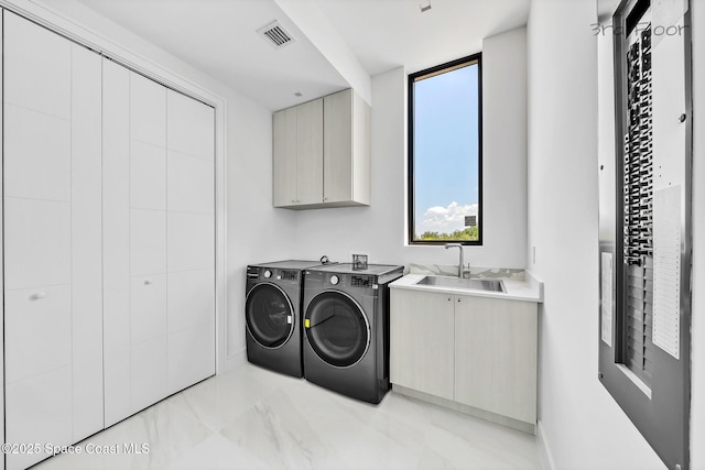 16 Seaside Ave, Key Largo, FL 33037 - washroom with washer and clothes dryer, cabinet space, and light marble finish floors