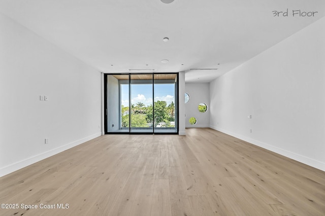 16 Seaside Ave, Key Largo, FL 33037 - empty room featuring floor to ceiling windows and light wood-type flooring