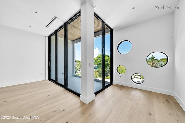 16 Seaside Ave, Key Largo, FL 33037 - foyer featuring a wall of windows and wood finished floors