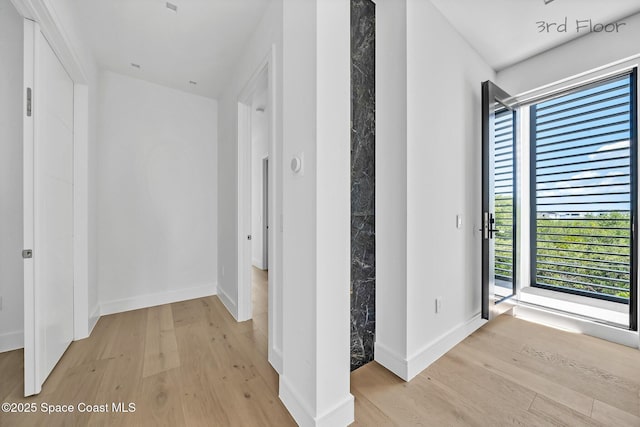 16 Seaside Ave, Key Largo, FL 33037 - hallway with light wood finished floors and plenty of natural light