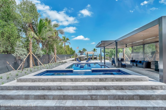 16 Seaside Ave, Key Largo, FL 33037 - view of swimming pool with an in-ground hot tub, a fenced backyard, a patio, and an outdoor living space