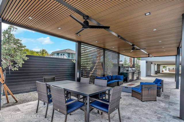 16 Seaside Ave, Key Largo, FL 33037 - view of patio featuring an outdoor living space with a fire pit, a ceiling fan, an outdoor kitchen, and outdoor dining space
