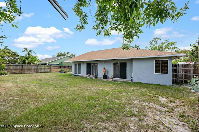 581 Jupiter Blvd NW, Palm Bay, FL 32907 - rear view of house featuring stucco siding and a fenced backyard