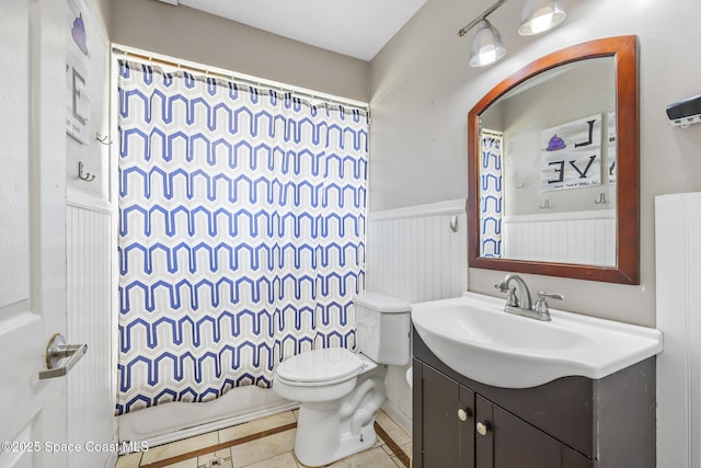 581 Jupiter Blvd NW, Palm Bay, FL 32907 - full bath featuring vanity, wainscoting, tile patterned flooring, and a shower with curtain