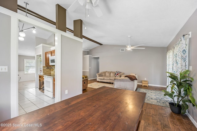 581 Jupiter Blvd NW, Palm Bay, FL 32907 - dining area with ceiling fan, lofted ceiling, and wood finished floors