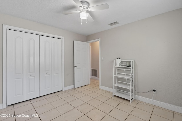 959 Macco Rd, Cocoa, FL 32927 - unfurnished bedroom with a closet, light tile patterned floors, and a ceiling fan