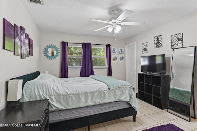959 Macco Rd, Cocoa, FL 32927 - bedroom featuring light tile patterned floors, ceiling fan, and a textured ceiling