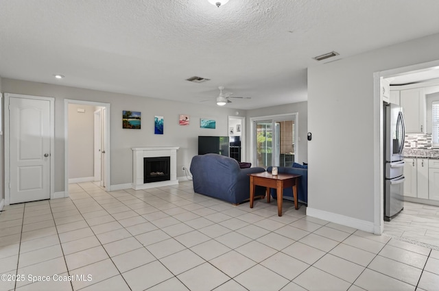 959 Macco Rd, Cocoa, FL 32927 - living room with ceiling fan, a fireplace with raised hearth, a textured ceiling, recessed lighting, and light tile patterned flooring