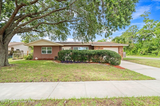 959 Macco Rd, Cocoa, FL 32927 - ranch-style home with a garage, brick siding, and driveway