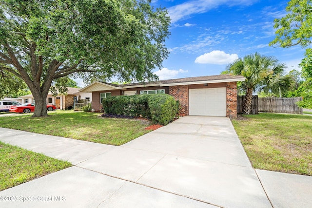 959 Macco Rd, Cocoa, FL 32927 - ranch-style house with an attached garage, brick siding, and concrete driveway
