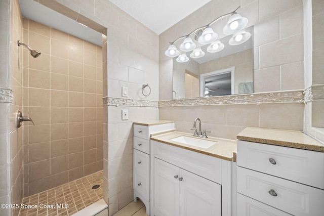 959 Macco Rd, Cocoa, FL 32927 - bathroom featuring tile walls, tiled shower, vanity, and tasteful backsplash